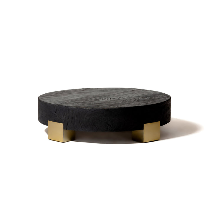 Grande table basse ronde en bois massif noir avec quatres pieds couleur bronze